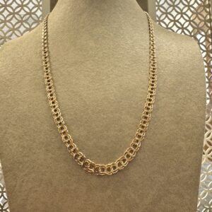 a gold chain on a mannequin